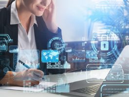 Businesswoman taking down notes while using computer with security