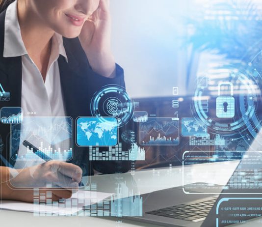 Businesswoman taking down notes while using computer with security