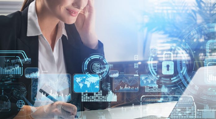 Businesswoman taking down notes while using computer with security