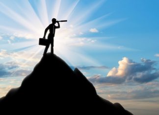 Finding Purpose and Making A Positive Impact in Your Career Silhouette of a businessman looking through a telescope
