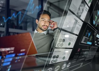 Addressing Customer Service Challenges and Leveraging Technology Businessman, digital interface and trading in analytics for stock market research, strategy or marketing at night office. Male trader with futuristic UI, UX or display for data statistics or analysis