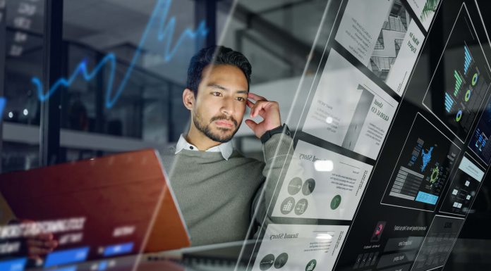 Addressing Customer Service Challenges and Leveraging Technology Businessman, digital interface and trading in analytics for stock market research, strategy or marketing at night office. Male trader with futuristic UI, UX or display for data statistics or analysis