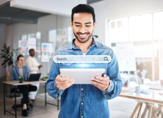 Businessman holding a tablet while browsing on the internet