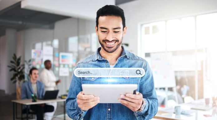 Businessman holding a tablet while browsing on the internet