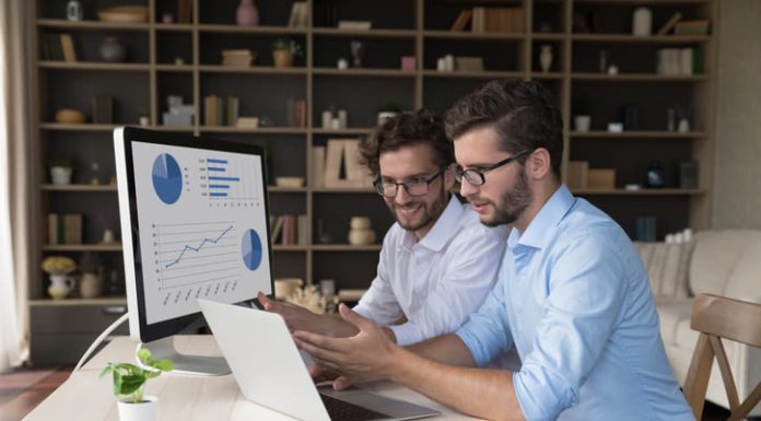 Employees collaborating on financial marketing reports