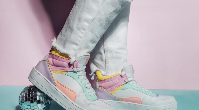 The Rise of Replica Sneakers: A Closer Look at Reps Shoes UK Close up photo of legs wearing retro style high-top multicolor sport sneakers shoes with disco ball on blue and pink background. Minimalism party, vintage retro style of 80s - 90s vibes.