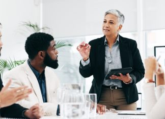 Shaping Future Leaders: The Critical Impact of Economics and General Paper Tutoring in Executive Education Business woman sharing idea and strategy with the members