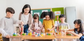Students playing at school together with their teacher