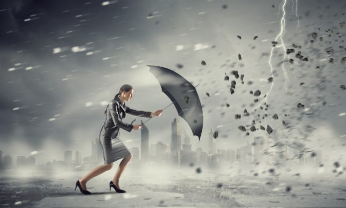 Woman with umbrella against disaster