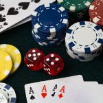 Poker chips, dice and 4 aces cards