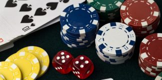 Poker chips, dice and 4 aces cards