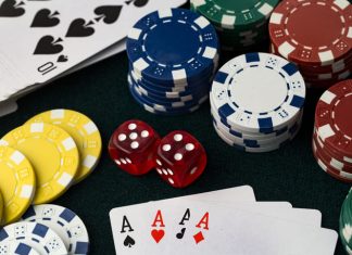 Poker chips, dice and 4 aces cards