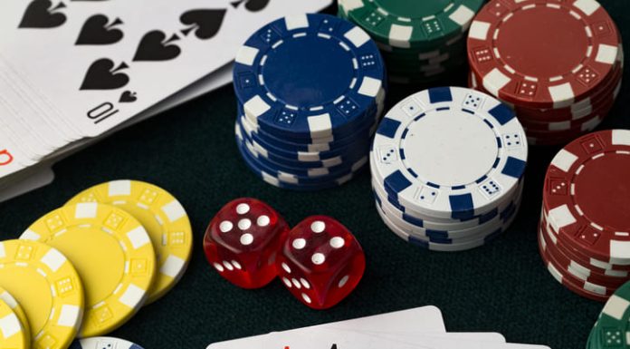 Poker chips, dice and 4 aces cards
