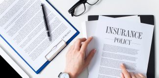 Business woman showing insurance document over white desk at office