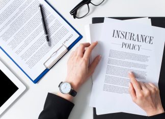 Business woman showing insurance document over white desk at office