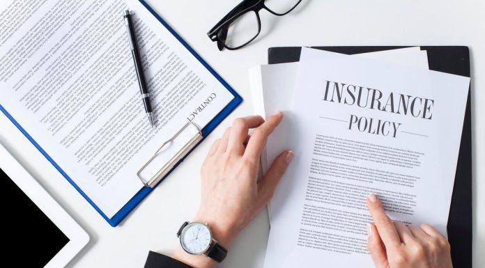 Business woman showing insurance document over white desk at office