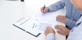 Businessman holding insurance policy for vehicle