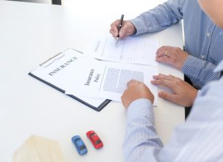 Businessman holding insurance policy for vehicle