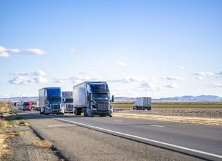 Semi trailers running on the divided highway road