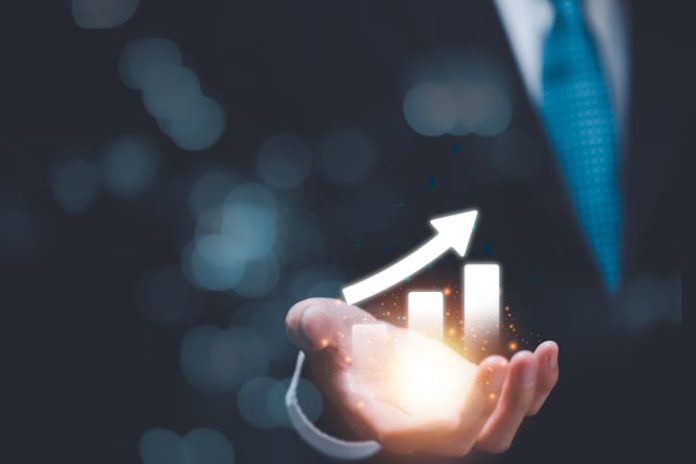 Businessman showing business growth and success graph