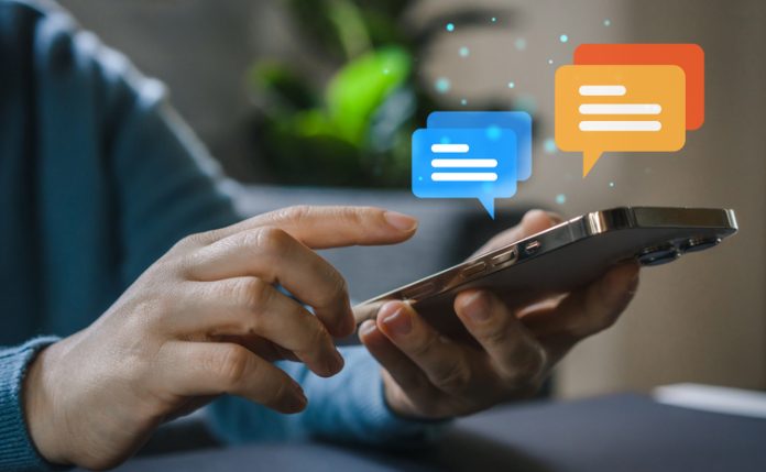 Human hand using smartphone typing Live chat chatting and social network concepts, chatting conversation working at home in chat box icons pop up. Social media marketing technology concept Person using smartphone for conversation