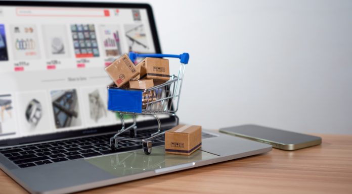 MDMaison Luxury Tableware E-commerce Platform Became One-Of-Its Kind With The Use Of AR and AI Technologies Shopping cart and product boxes placed on laptop computer for e-commerce