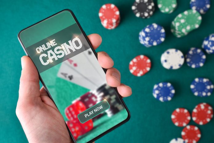Hand with smartphone showing screen with online casino game iStock-1839902634.jpg