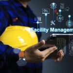 Engineer holding yellow helmet and tablet to monitoring maintenance application technology