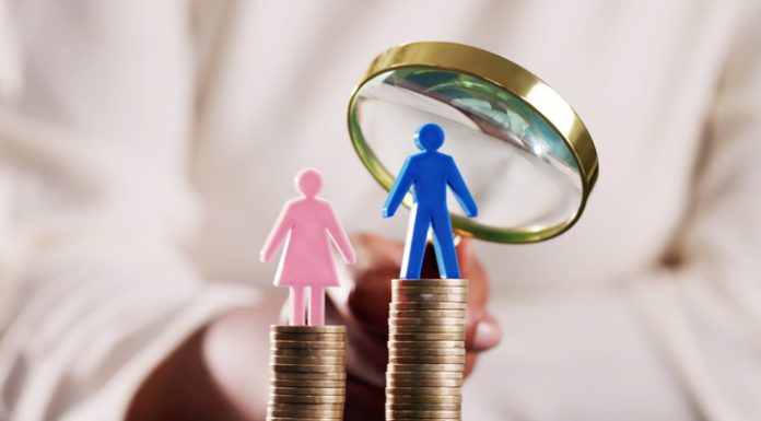 Coin stacks with gender symbol and magnifying glass