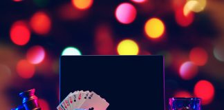 Gavel, playing cards and chips on computer