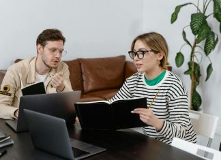 Man and Woman Discussing in Workplace