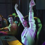 Saudi Arabia to Host Inaugural Olympics Esports Games in 2025 Photo side view happy woman winning at videogame