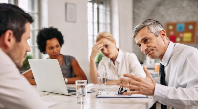 Angry businessman discussing with colleague