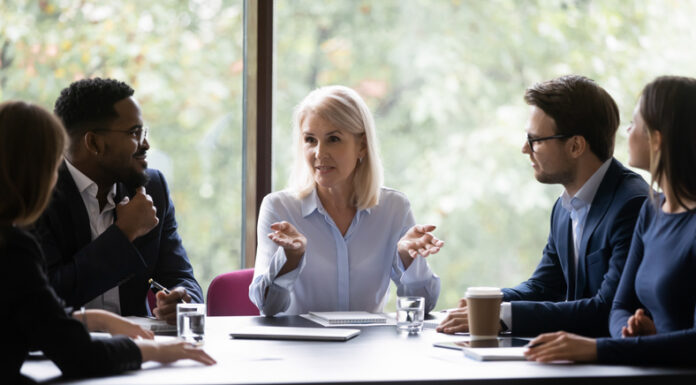 Mature leader boss give helpful information to young professionals