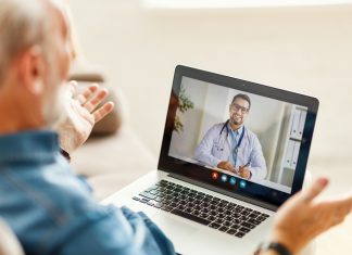 Elderly person having a video call with a doctor