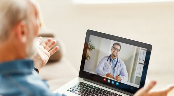 Elderly person having a video call with a doctor