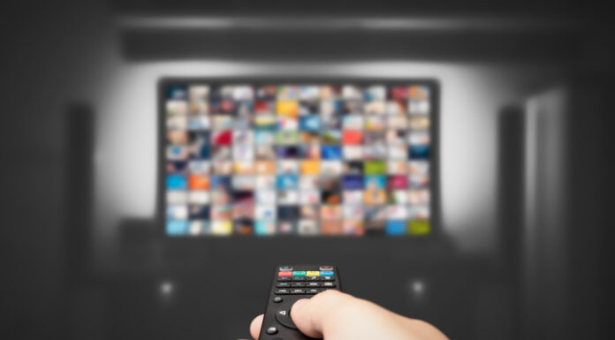 Hand holding remote control for TV