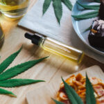 Exploring the Various Methods of Consuming Marijuana Food and drink and cannabis oil on the dining table. Alternative medicine concept.