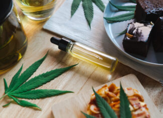 Food and drink and cannabis oil on the dining table. Alternative medicine concept.