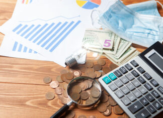 Impact of Force Majeure on Small and Medium-Sized Businesses in Poland as Exemplified by the COVID-19 Pandemic: Lessons for the Future Pandemic cost with calculator, magnifier and coins