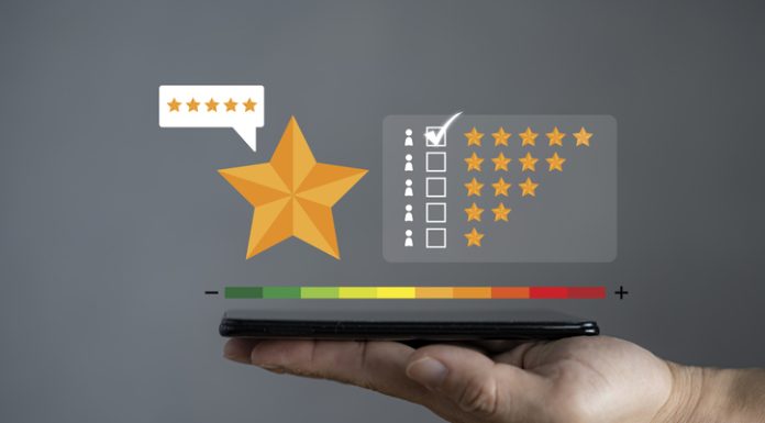 Smartphone screen with gold five star rating feedback