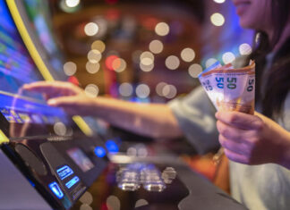 Female Gambler Hand hold money bill ready to win the game with one best shot casino