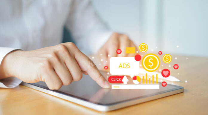 Close up businessman hand touch screen on digital tablet checking traffic research of pay per click program on web page for online business