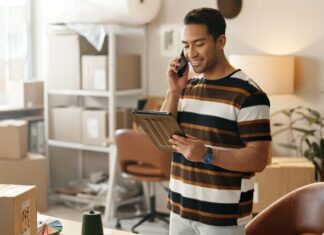 Man, phone call and boxes for online logistics, startup communication and small business courier on tablet