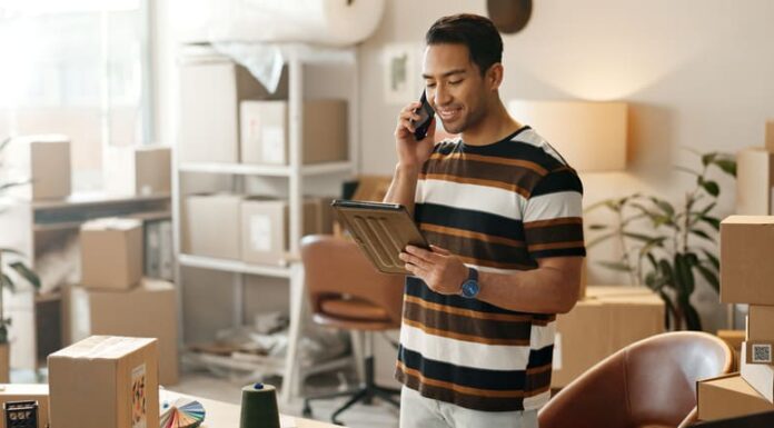 Man, phone call and boxes for online logistics, startup communication and small business courier on tablet