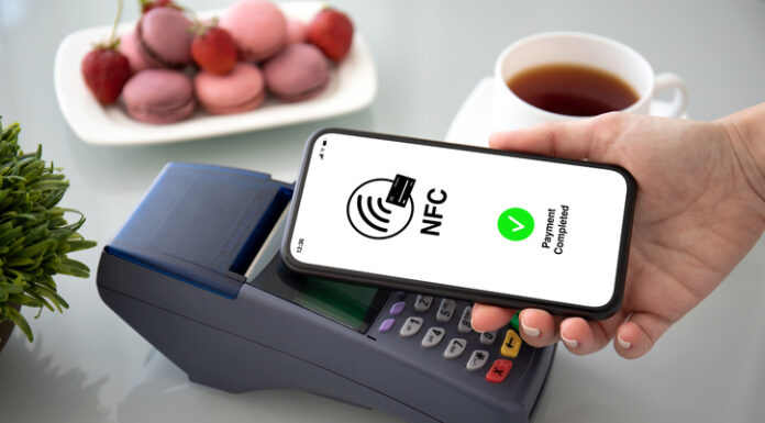 Female hands phone pay wireless technology nfc via pos terminal
