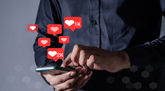 Man using smart phone with Social Media icon