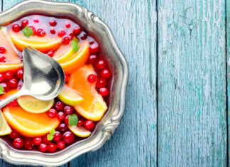 Alcoholic cocktail with pieces of fruit and berries