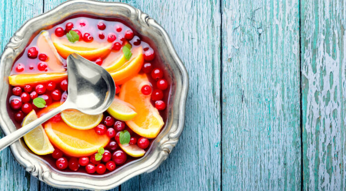 Alcoholic cocktail with pieces of fruit and berries