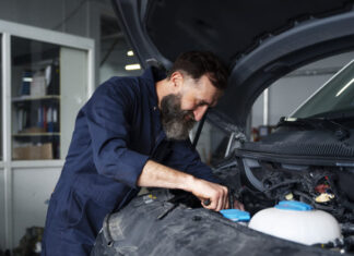 Male mechanic working on car in the auto repair shop